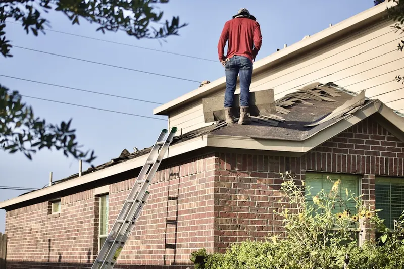 Professional roofer working on a residential roof in Thornapple